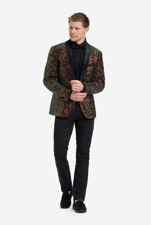 Man wearing a sequins blazer over a black shirt and pants on a white background. Full body image