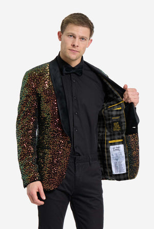 Man wearing a sequined blazer over a black shirt and pants on a white background. Showing the inside of his jacket
