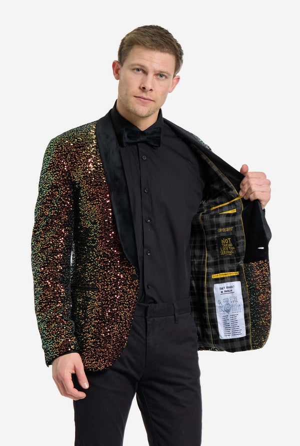 Man wearing a sequined blazer over a black shirt and pants on a white background. Showing the inside of his jacket