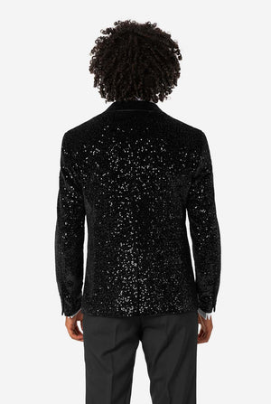 Person wearing a black sequin jacket on a white background
