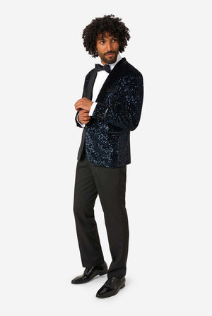 Man wearing a navy sequin blazer over a black tuxedo on a white background