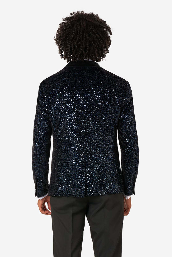 Person wearing a navy sequin jacket on a white background