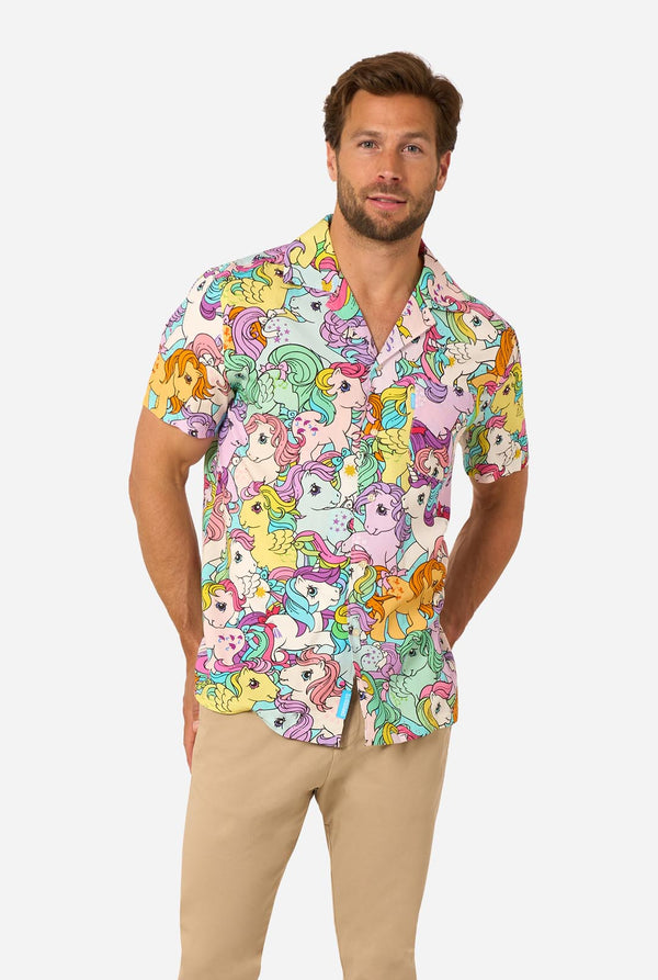 Man wearing a colorful My Little Pony shirt with cartoon character pattern on a white background
