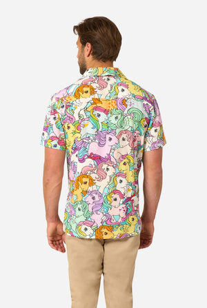 Man wearing a colorful My Little Pony shirt with cartoon character pattern on a white background. View from the back