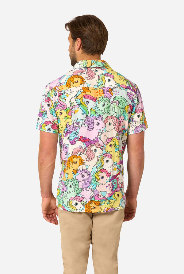 Man wearing a colorful My Little Pony shirt with cartoon character pattern on a white background. View from the back