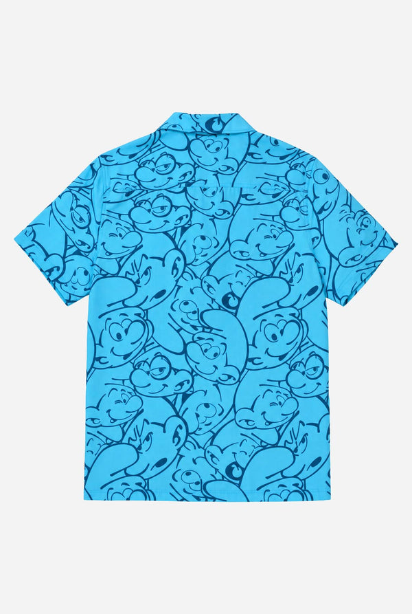 Blue shirt with Smurfs character pattern on a white background. View from the back.