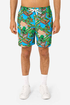 Person wearing colorful Minecraft-themed shorts on a white background