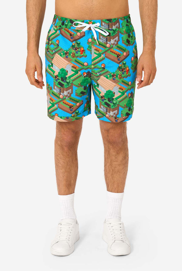 Person wearing colorful Minecraft-themed shorts on a white background