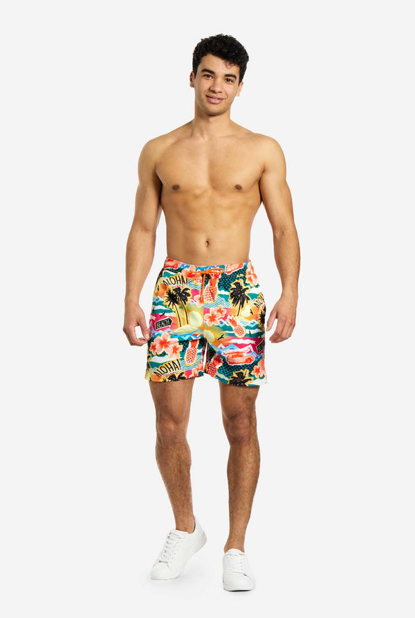 Man wearing swim trunks with tropical Hawaiian print
