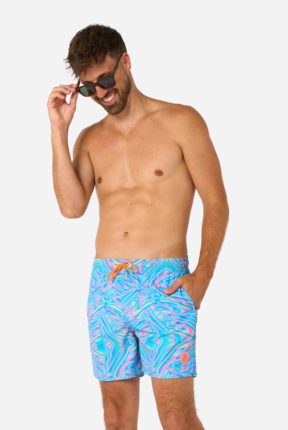 Colorful geometric patterned Holoperfect swim shorts on a plain background