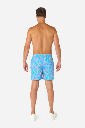 Man wearing colorful Holoperfect swim shorts on a white background. View from the back