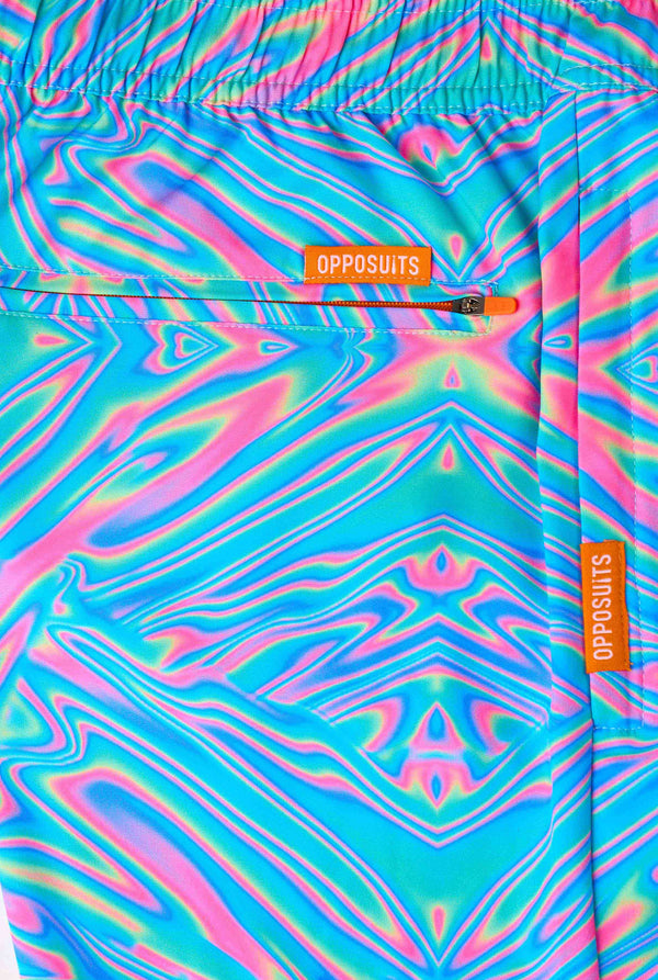 Colorful Holoperfect swim shorts with 'OPPOSUITS' branding on a matching bag.
