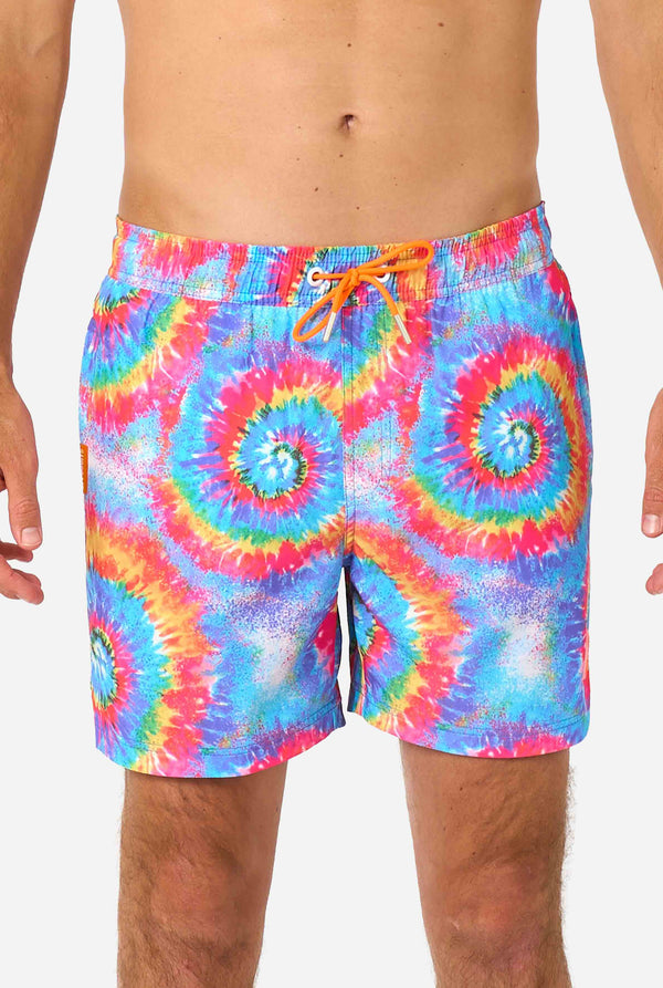 Tie-dye swim shorts with a colorful spiral pattern on a white background