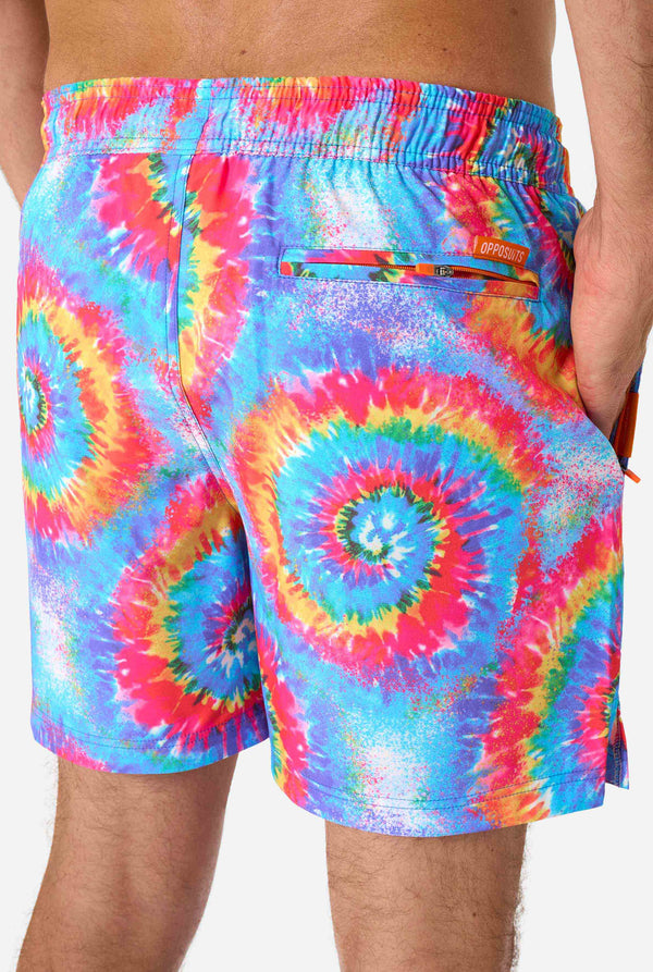 Multicolored tie-dye shorts with a brand logo on a plain background