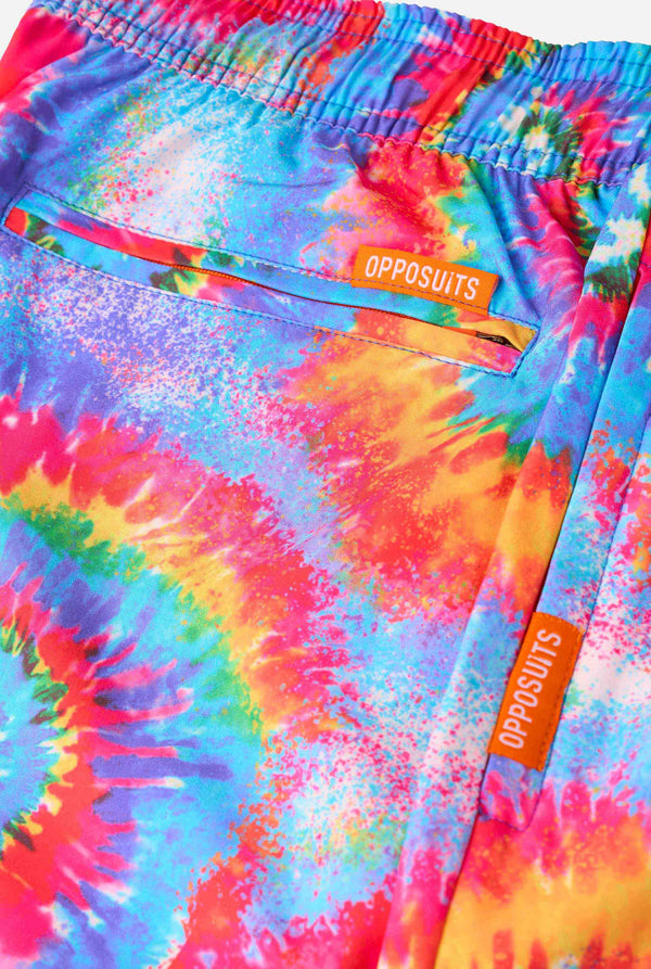 Colorful tie-dye swim shorts with 'OPPOSUITS' branding on a multicolored background.