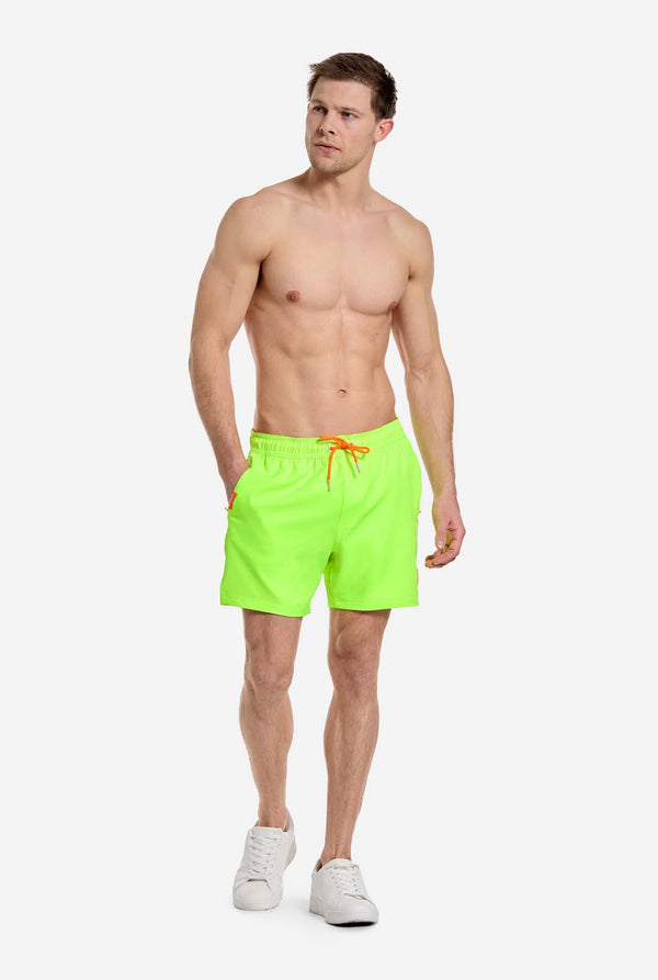 Man wearing Neon lime green swim trunks for men