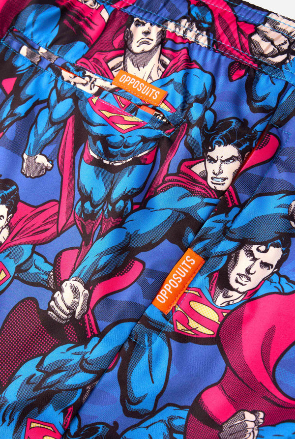 Superman-themed fabric with colorful design and 'Opposuits' branding.
