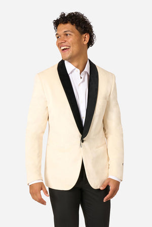 Man wearing a cream blazer with black lapels and trim on a light background