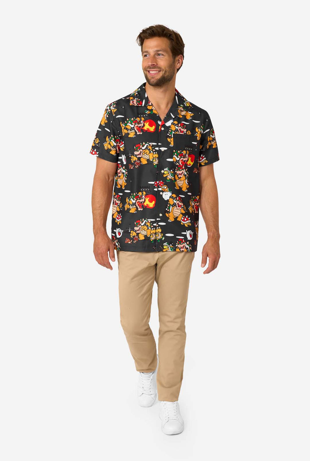 Man wearing a black Hawaiian shirt with colorful Bowser character print on a white background