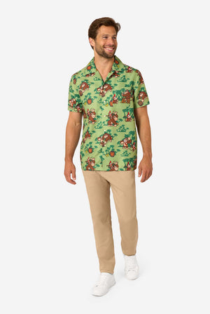 Man wearing a green Donkey Kong patterned shirt and beige pants on a white background