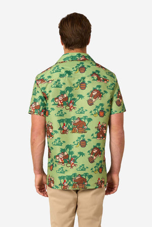 Person wearing a green patterned shirt with Donkey Kong characters on a white background