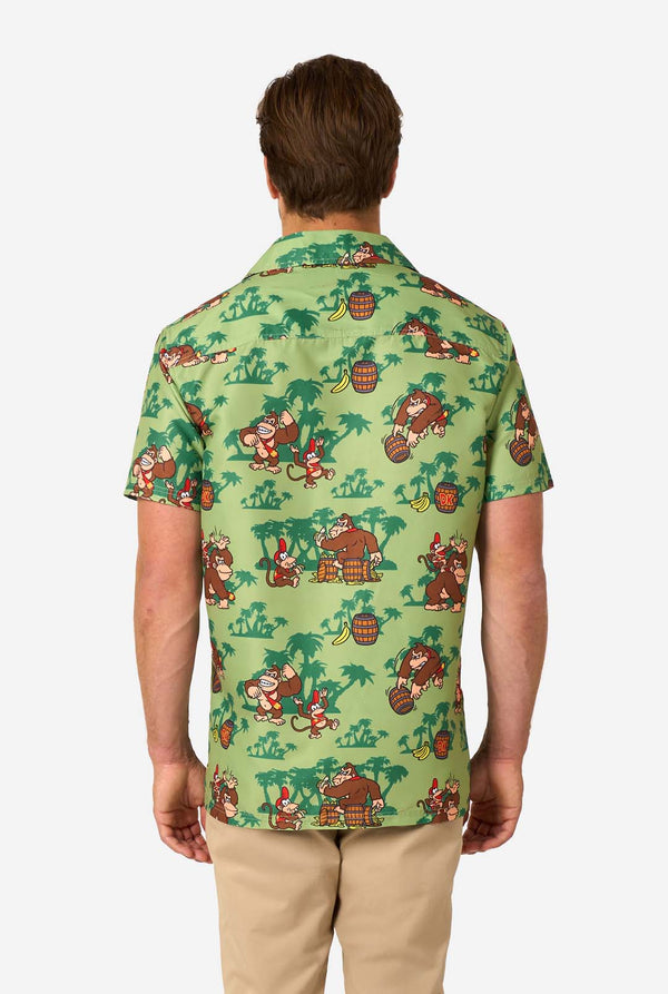 Person wearing a green patterned shirt with Donkey Kong characters on a white background