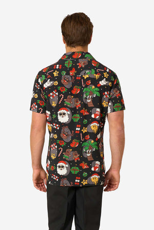 Person wearing a black short-sleeve shirt with colorful Christmas-themed graphics on a white background