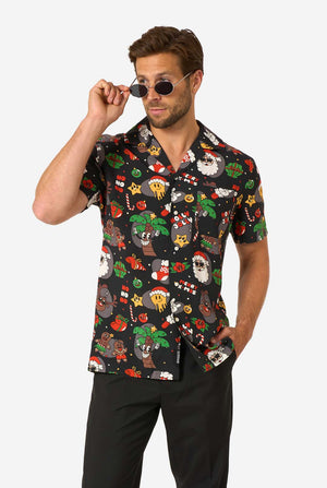 Man wearing a colorful patterned shirt with a white background