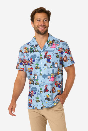 Man wearing a colorful shirt with Mario character patterns on a light gray background