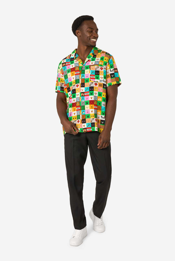 Man wearing a colorful patterned Minecraft shirt on a white background