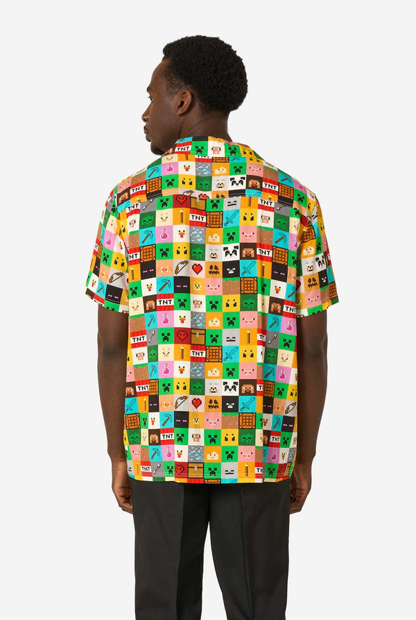 Person wearing a colorful patterned Minecraft shirt with a white background