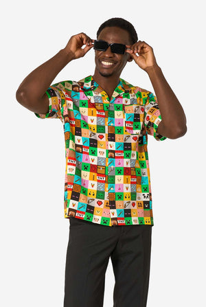 Man wearing a colorful patterned Minecraft shirt and sunglasses on a white background