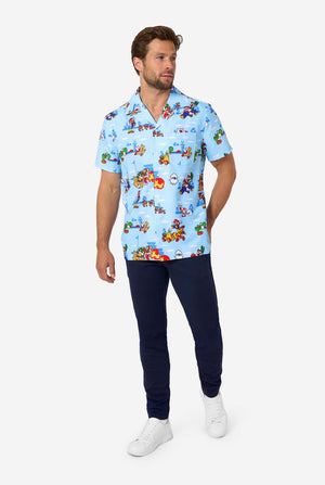 Man wearing a colorful patterned Mario shirt and dark pants on a white background