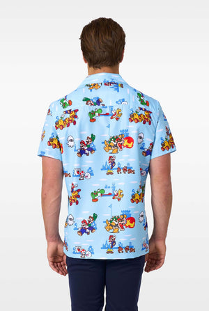 Person wearing a blue shirt with colorful Mario character pattern on a white background