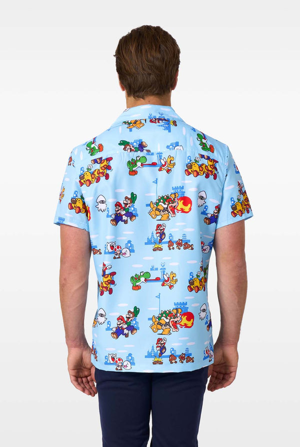 Person wearing a blue shirt with colorful Mario character pattern on a white background