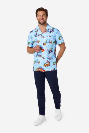 Man wearing a light blue scrub top with Mario character print and dark pants on a white background