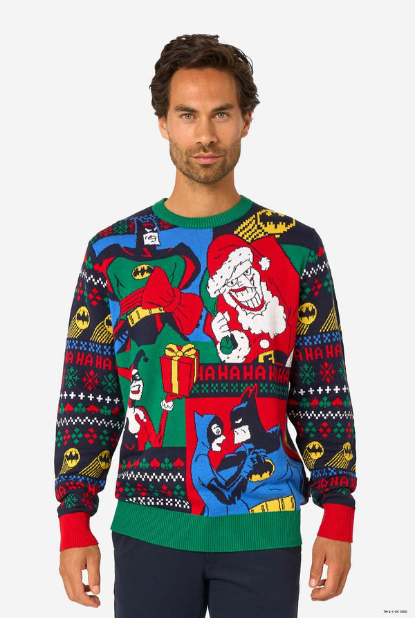 Man wearing a colorful Christmas sweater with Batman characters on a white background