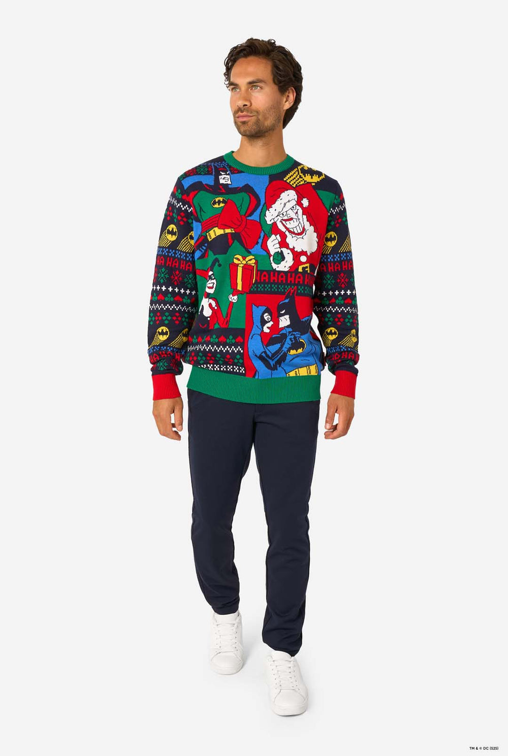 Man wearing a colorful Christmas sweater with Batman characters on a white background