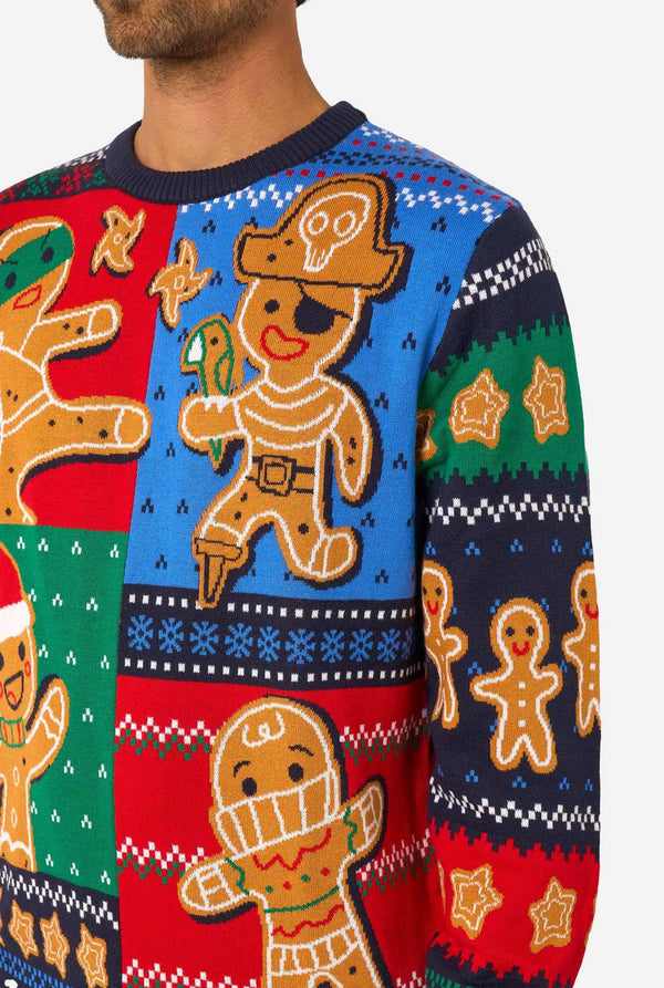 Colorful sweater with gingerbread man design on a plain background