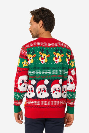 Man wearing a festive Christmas sweater with reindeer and Santa Claus designs. View from the back