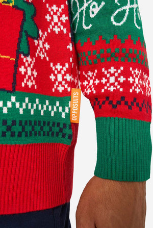 Close-up of a red and green Christmas sweater with 'Opposuits' branding.