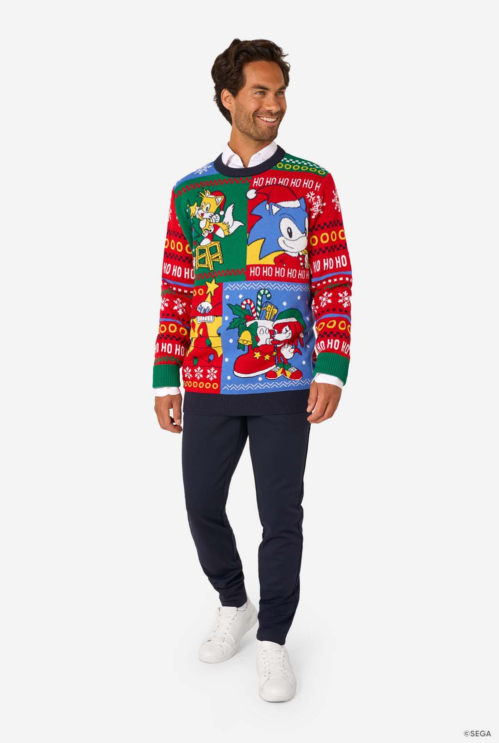 Man wearing a colorful Christmas sweater with Sonic characters and text.