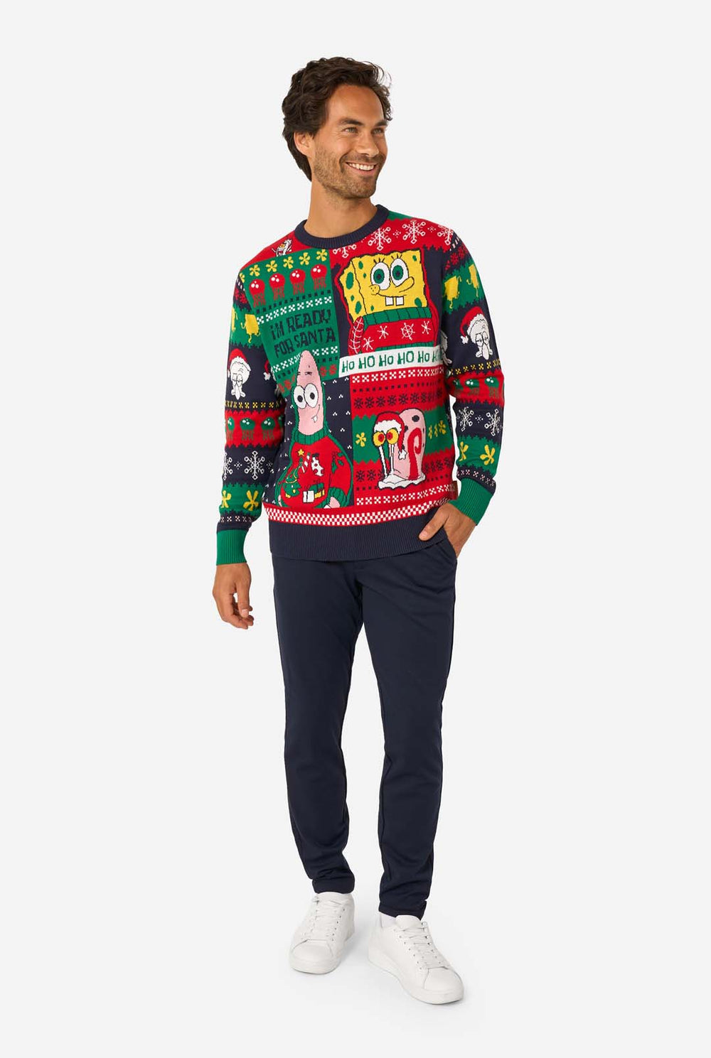 Man wearing a colorful Christmas-themed sweater with Spongebob character designs on a white background