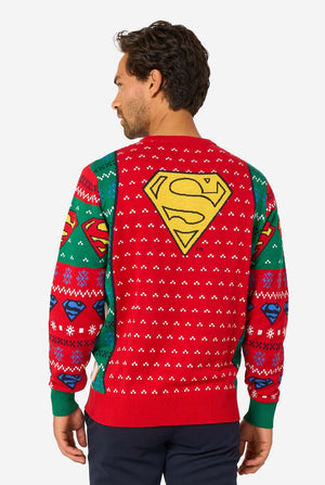 Man wearing a Superman-themed Christmas sweater with colorful patterns on a white background. View from the back