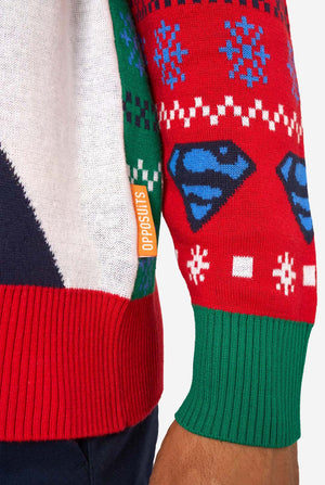 Colorful sweater with Superman logos and a visible brand label on a white background