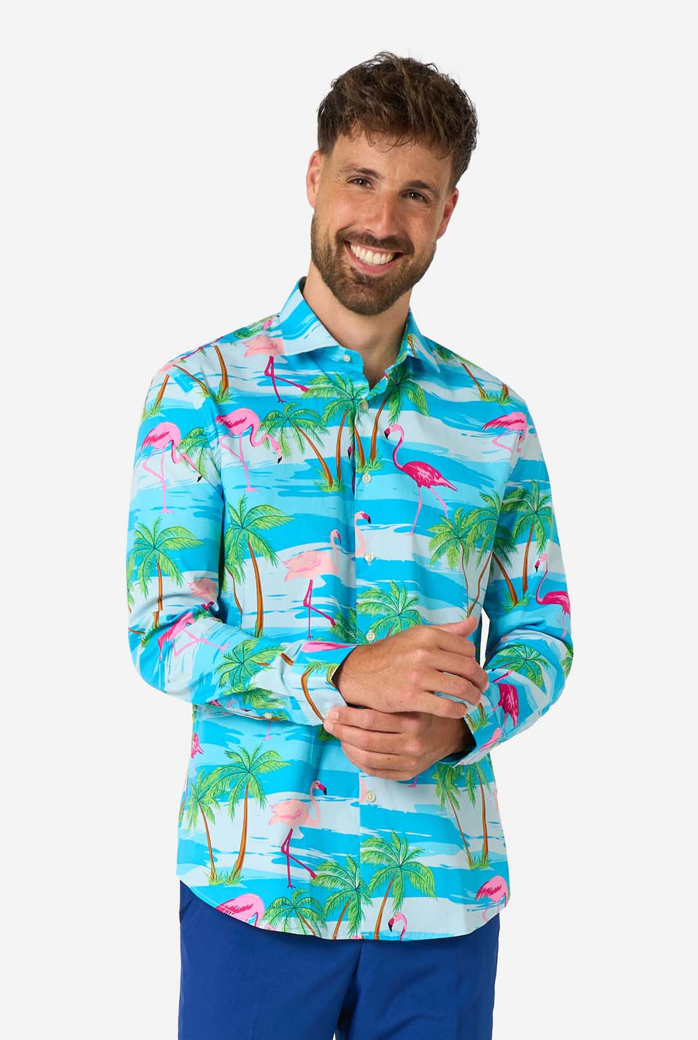 Man wearing a colorful tropical shirt with flamingos and palm trees on a white background