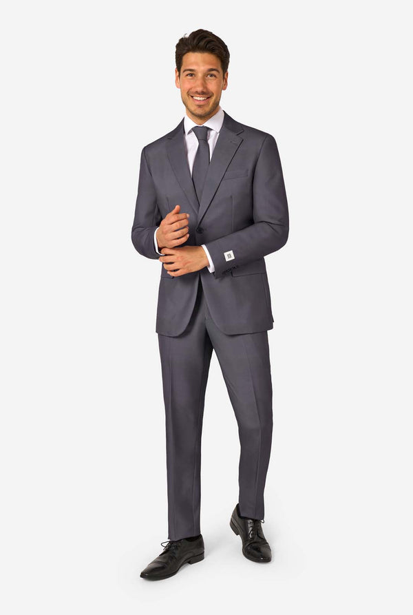 Man wearing a gray suit with a white shirt and black shoes on a white background. Full body image