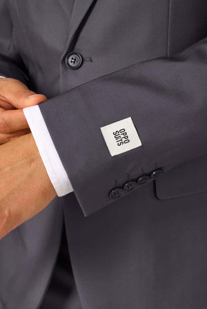 Close-up of a gray suit jacket with a brand label on the sleeve.