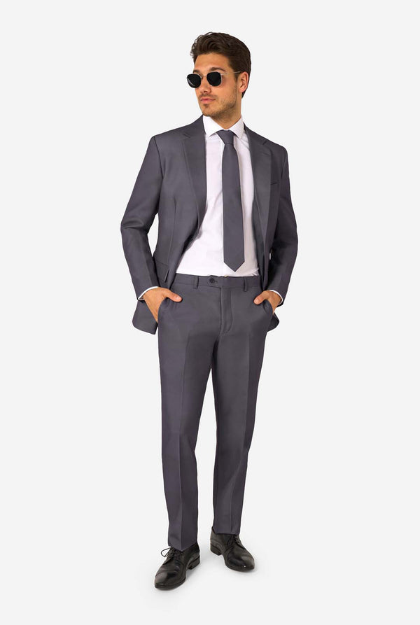Man wearing a gray suit with sunglasses on a white background. Full body image
