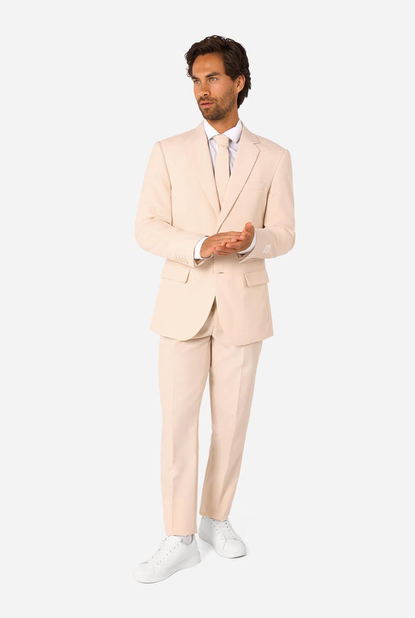 Man wearing a sand colored suit on a white background. Full body image